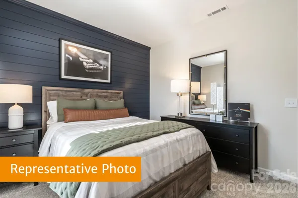 a bedroom with a bed and dresser