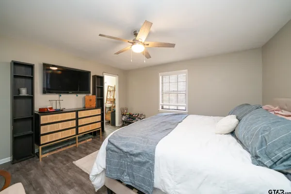 a bedroom with a bed and a flat screen tv