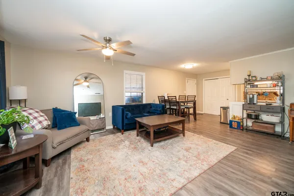 a living room with furniture and wooden floor
