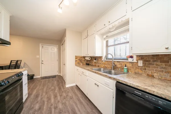 a kitchen with a sink stove and cabinets