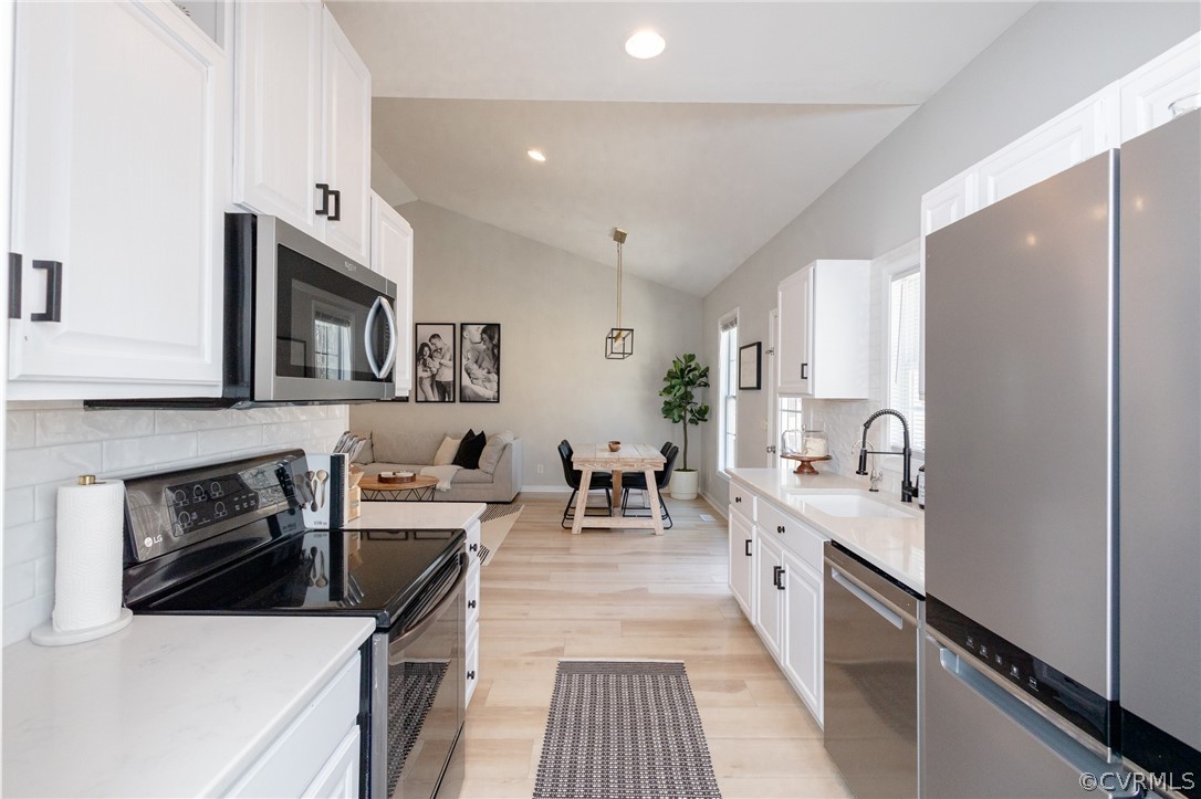 2406 Emanuel Church Road Powhatan, VA 23139 - Photo 20 of 50 a kitchen with stainless steel appliances a stove microwave and cabinets