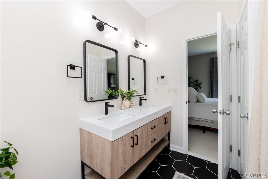 2406 Emanuel Church Road Powhatan, VA 23139 - Photo 27 of 50 a bathroom with a double vanity sink and a mirror