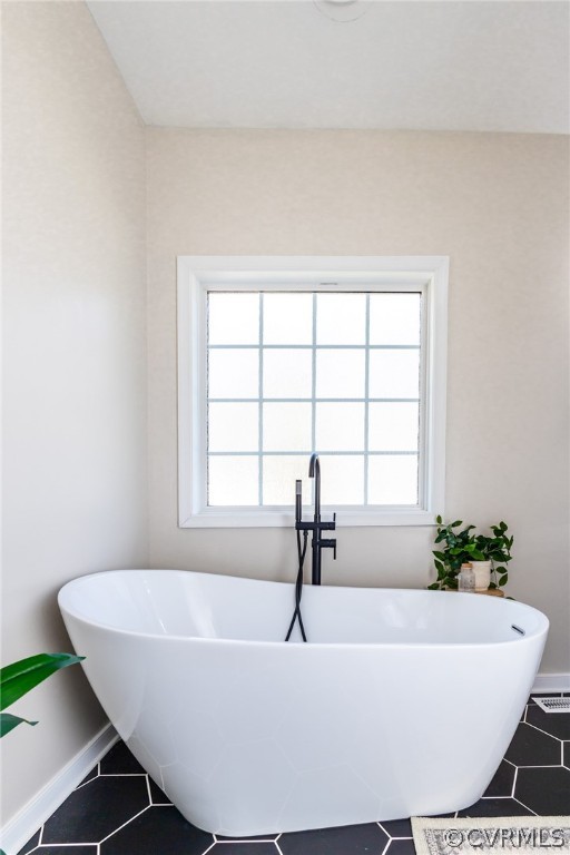 2406 Emanuel Church Road Powhatan, VA 23139 - Photo 30 of 50 a white bath tub sitting in a bathroom next to a window