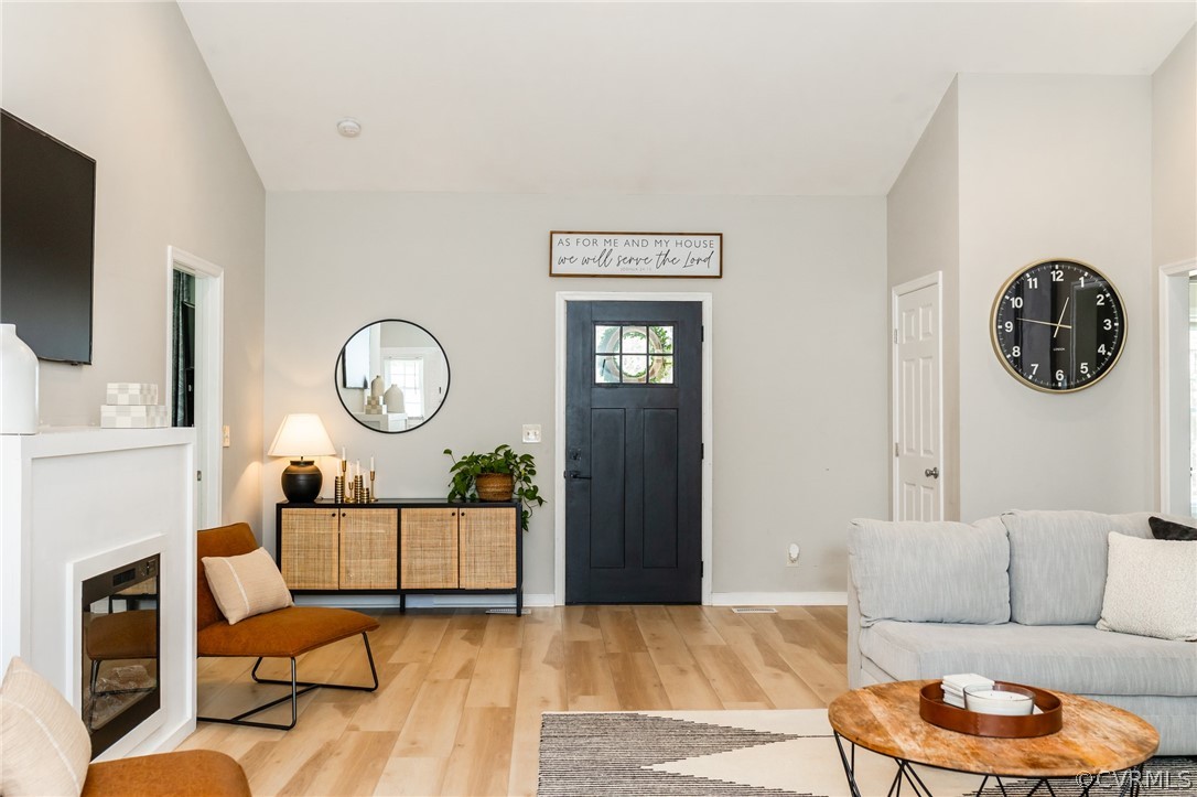 2406 Emanuel Church Road Powhatan, VA 23139 - Photo 5 of 50 a living room with furniture a flat screen tv and a large window