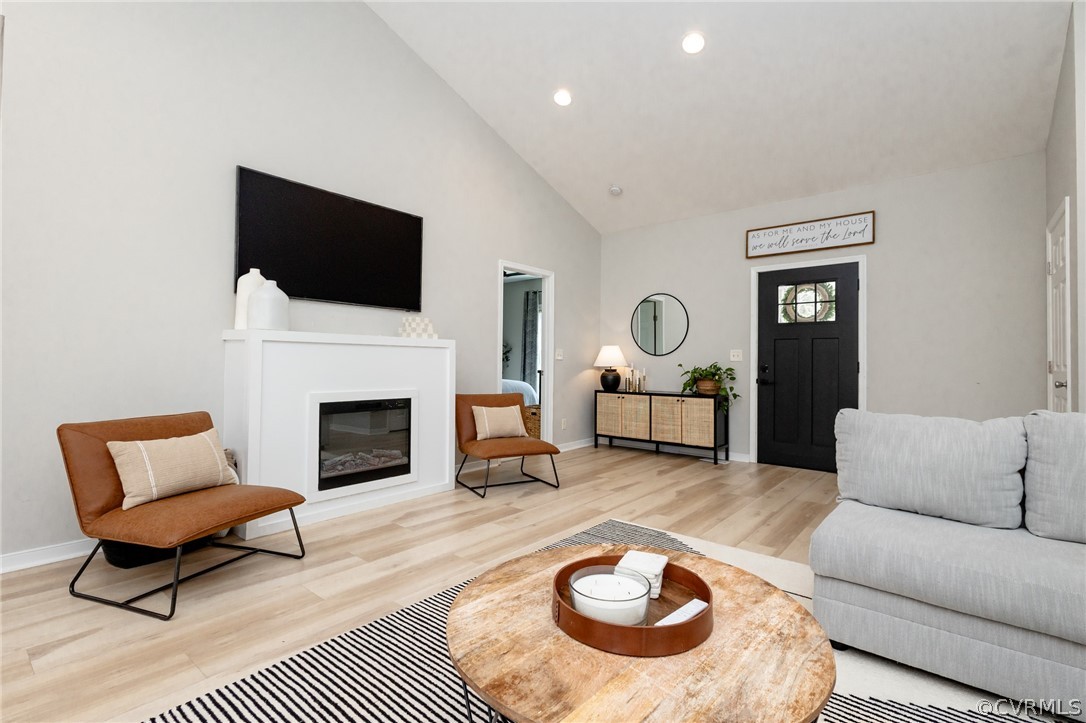 2406 Emanuel Church Road Powhatan, VA 23139 - Photo 8 of 50 a living room with furniture a flat screen tv and a fireplace