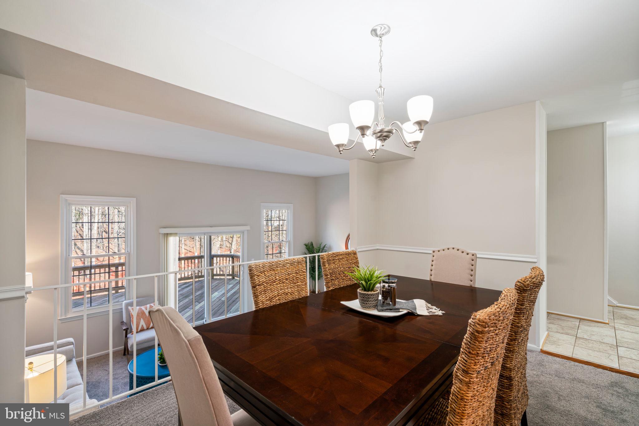5702 Kirkham Court Springfield, VA 22151 - Photo 36 of 36 a view of a dining room with furniture a chandelier and wooden floor