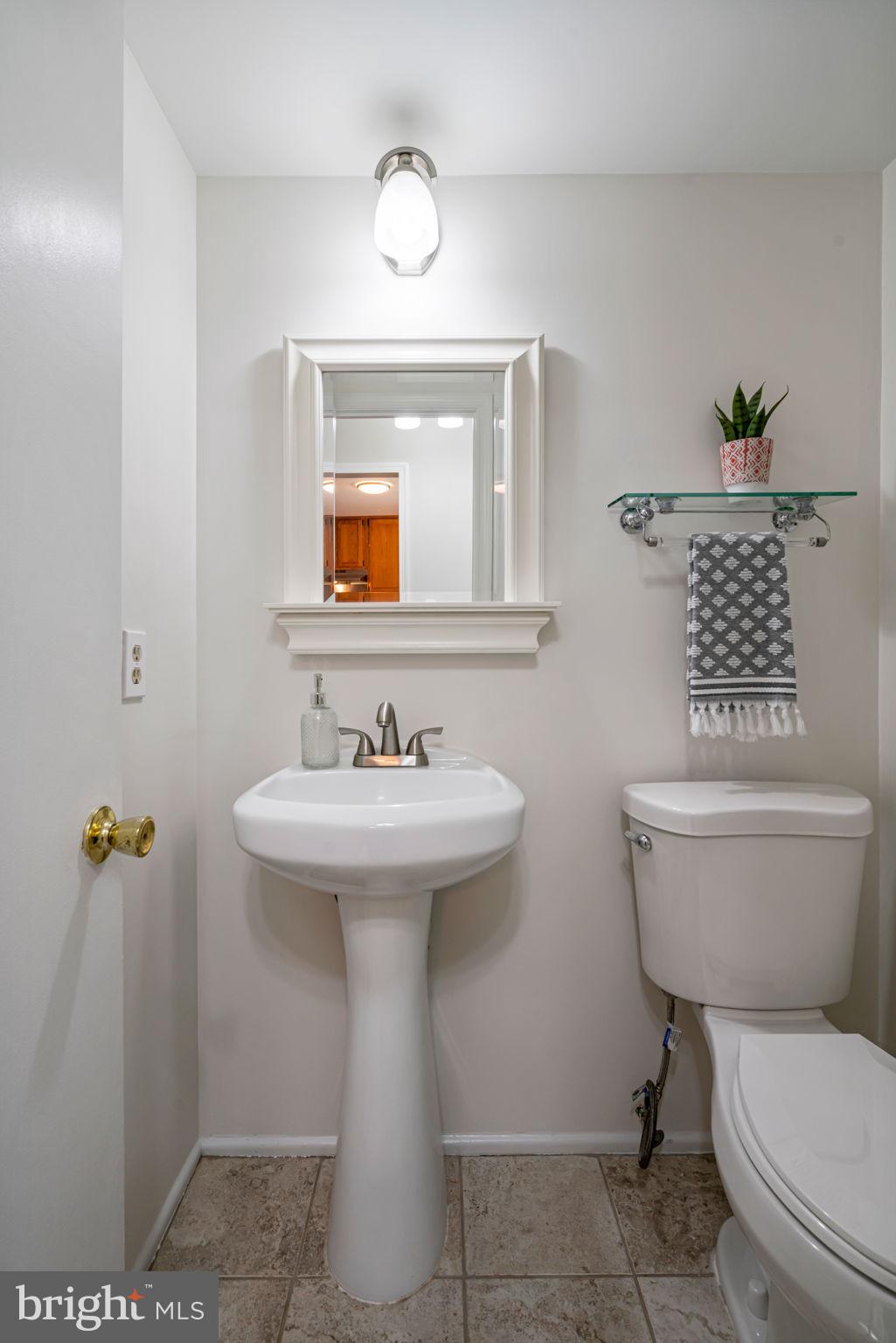 5702 Kirkham Court Springfield, VA 22151 - Photo 16 of 36 a bathroom with a sink a toilet and mirror