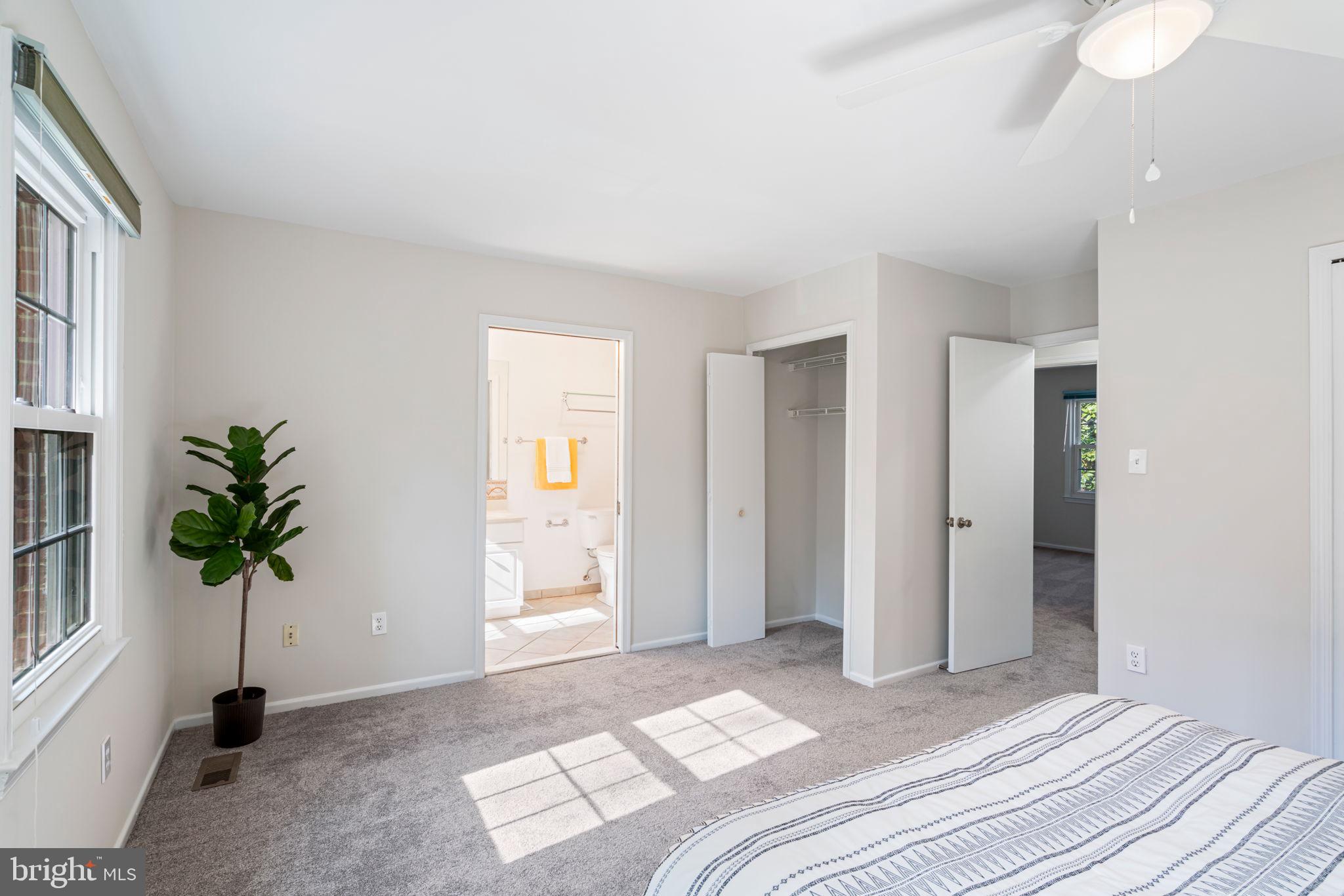 5702 Kirkham Court Springfield, VA 22151 - Photo 19 of 36 a bedroom with a bed and a potted plant
