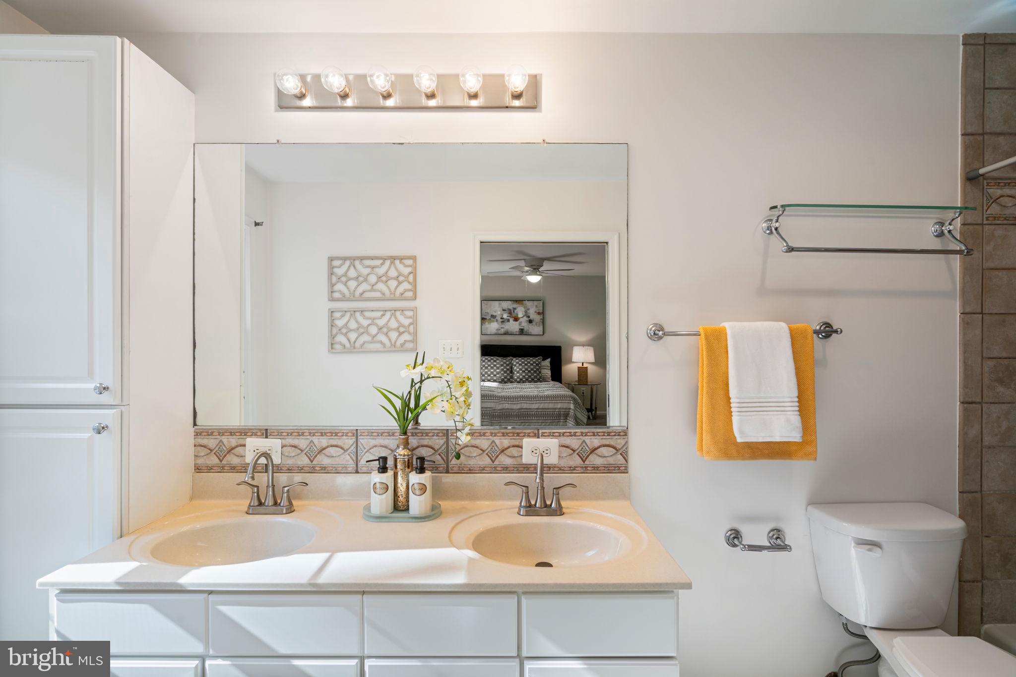 5702 Kirkham Court Springfield, VA 22151 - Photo 20 of 36 a bathroom with a sink double vanity and a toilet