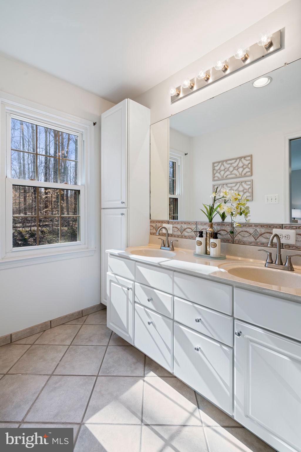 5702 Kirkham Court Springfield, VA 22151 - Photo 21 of 36 a bathroom with a sink mirror and