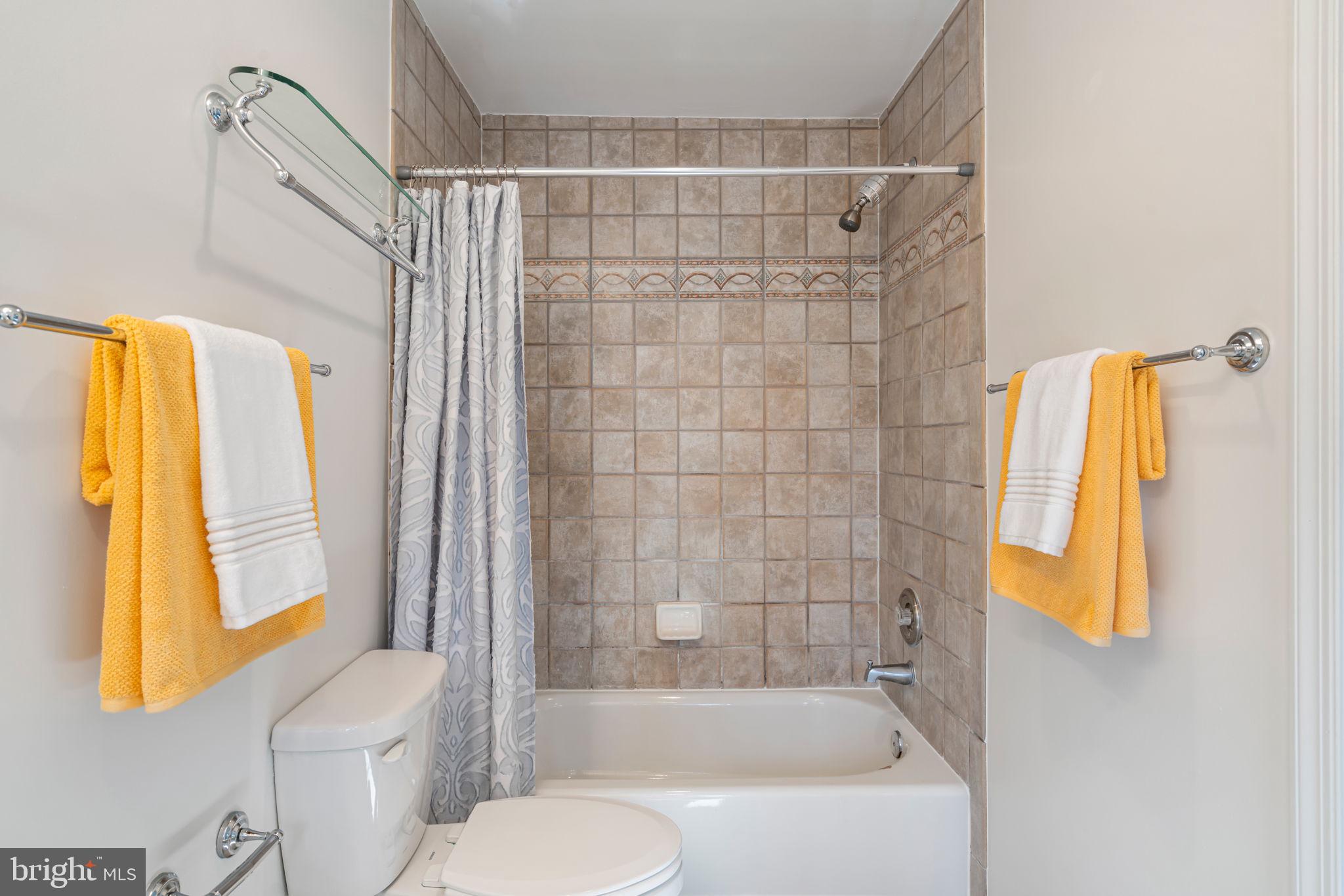 5702 Kirkham Court Springfield, VA 22151 - Photo 22 of 36 a bathroom with a shower curtain and a bathtub
