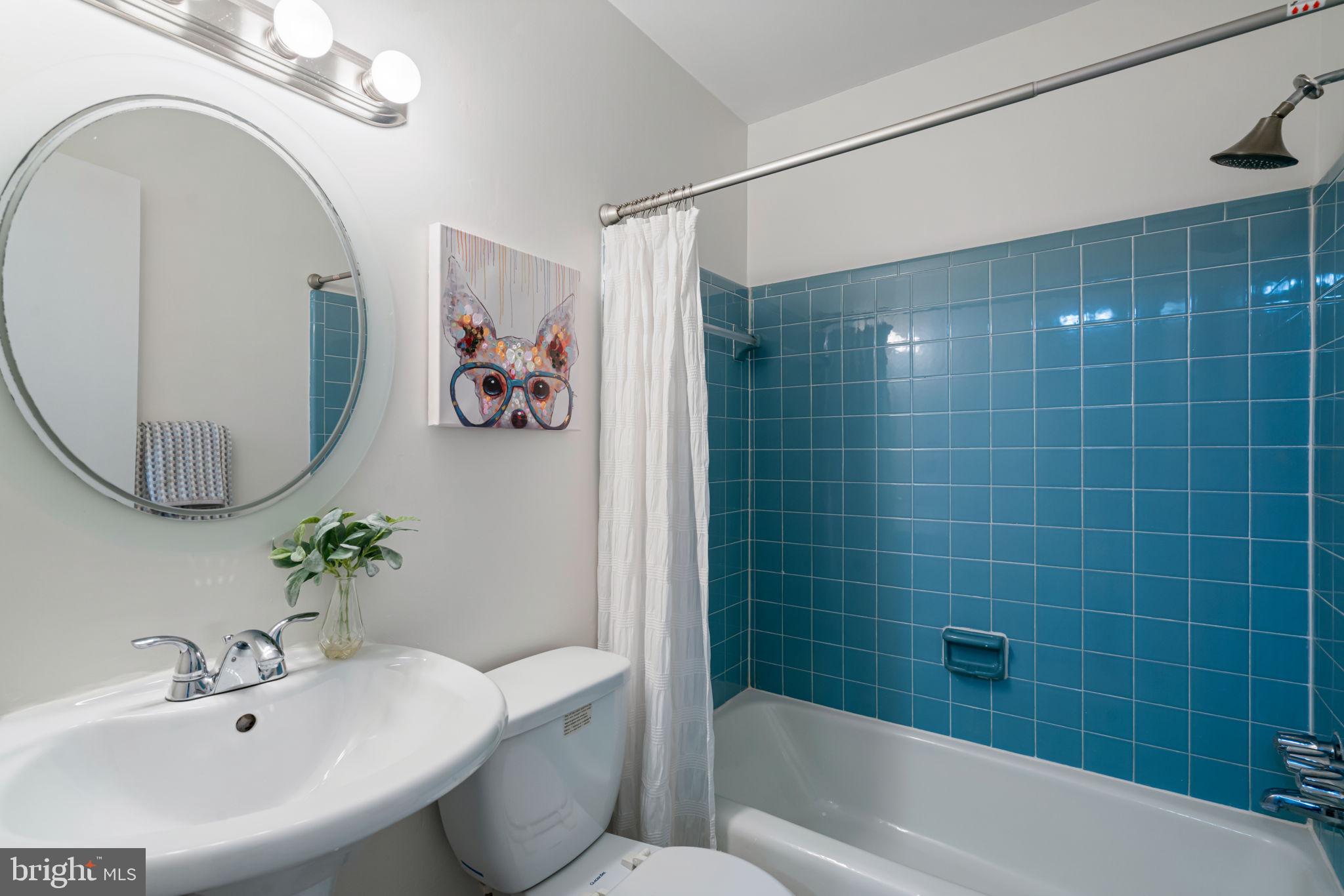 5702 Kirkham Court Springfield, VA 22151 - Photo 27 of 36 a bathroom with a sink a mirror a bathtub and shower