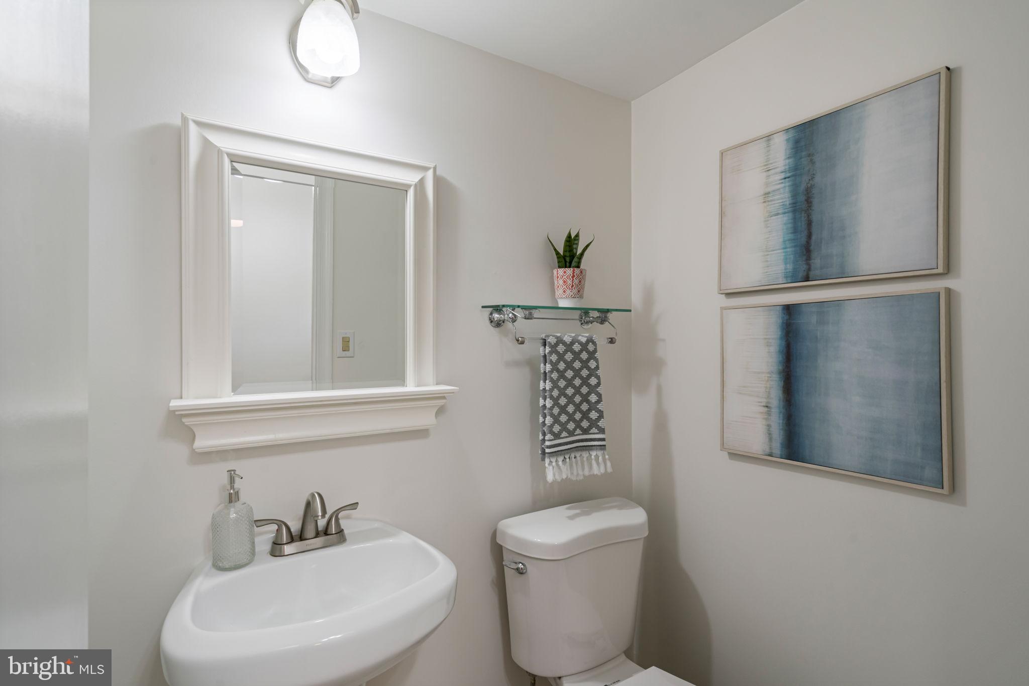 5702 Kirkham Court Springfield, VA 22151 - Photo 28 of 36 a bathroom with a toilet sink and mirror
