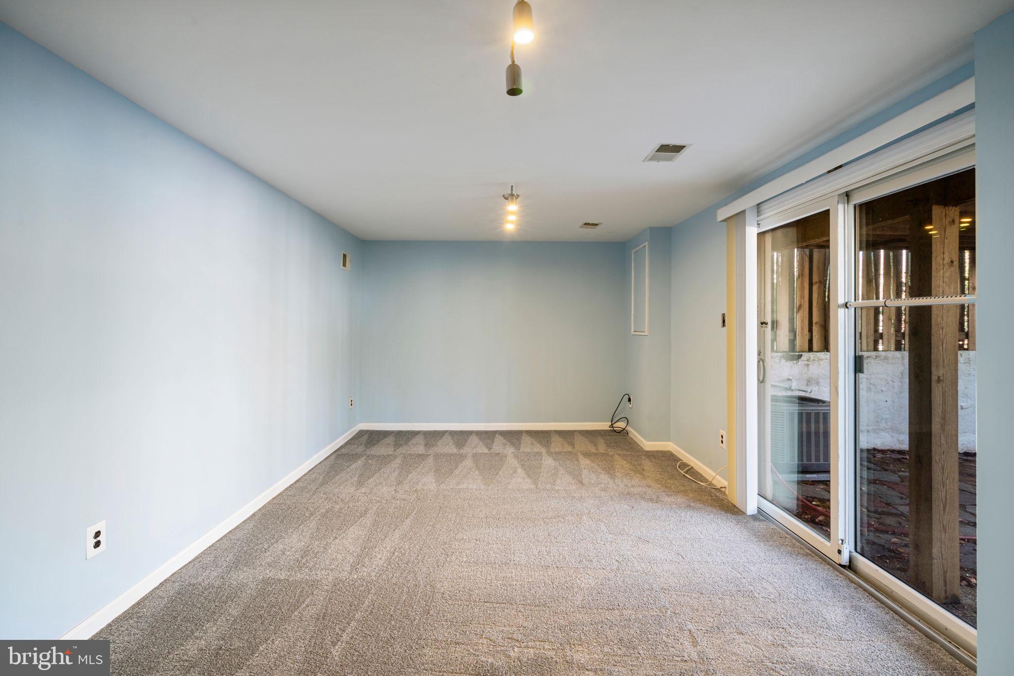 5702 Kirkham Court Springfield, VA 22151 - Photo 32 of 36 an empty room with sliding door