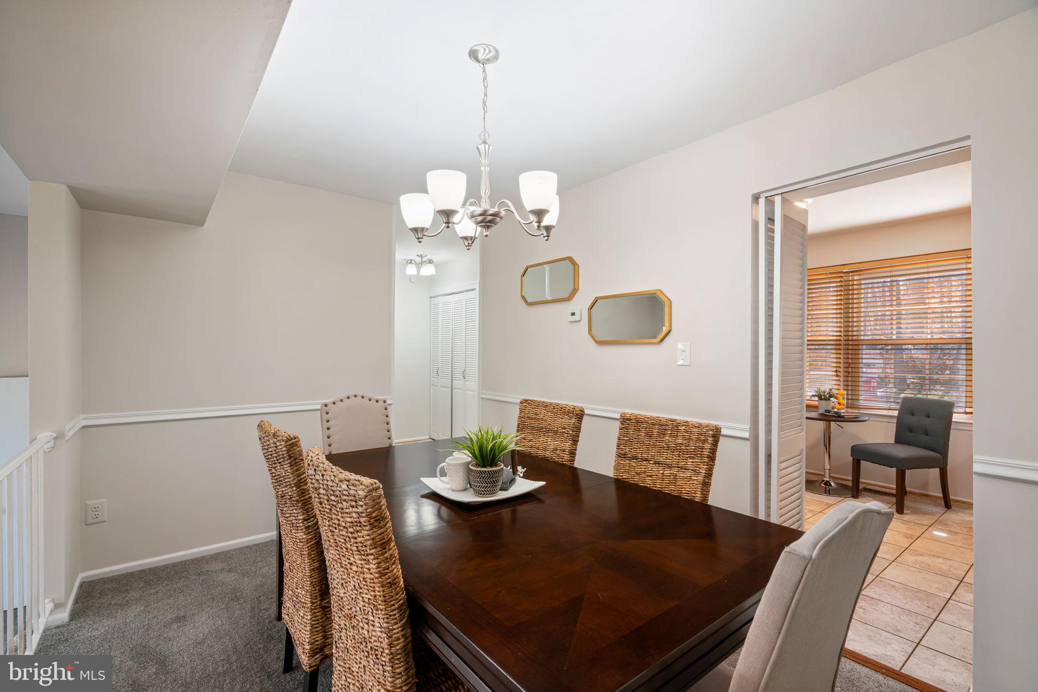 5702 Kirkham Court Springfield, VA 22151 - Photo 9 of 36 a view of a dining room with furniture and wooden floor