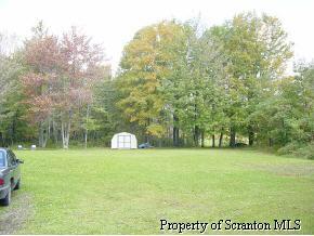 0 Rr1, Unit 105BRYN Springville, PA 18844 - Photo 3 of 5 a view of a field with trees in the background