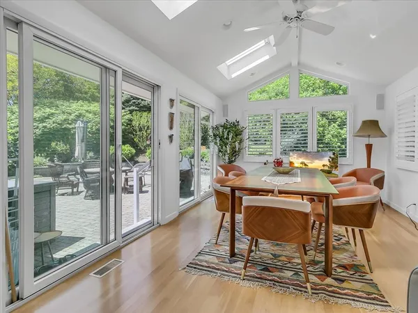 a view of a dining room with furniture a chandelier and wooden floor