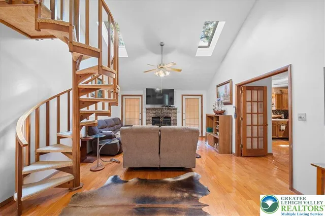 a living room with furniture or chandelier and a wooden floor