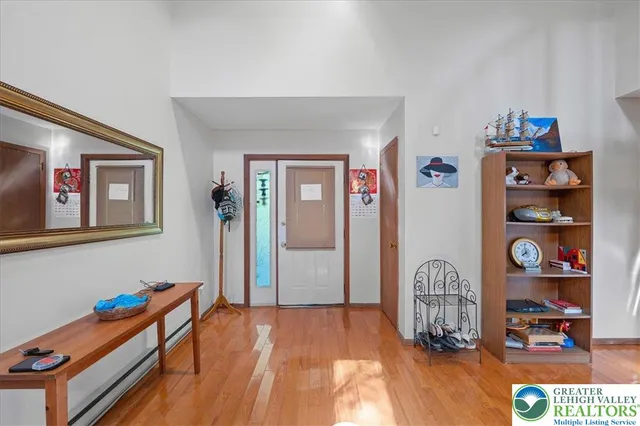 a kitchen with granite countertop a refrigerator a sink dishwasher a dining table and chairs with wooden floor