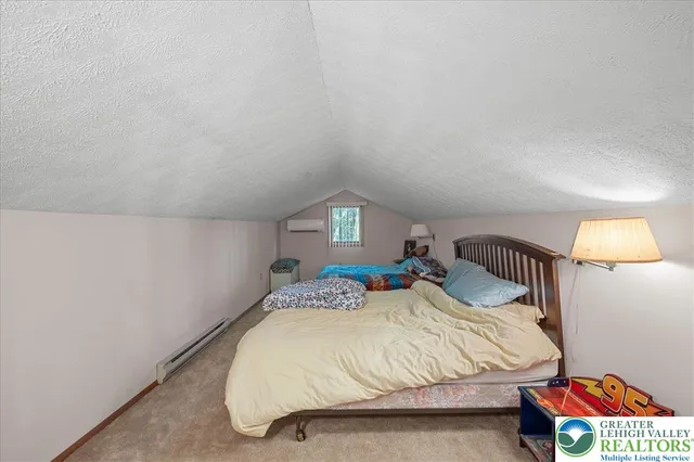 a bedroom with two beds and a lamp