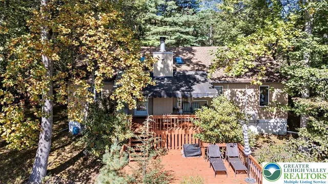 an aerial view of a house with yard and outdoor seating