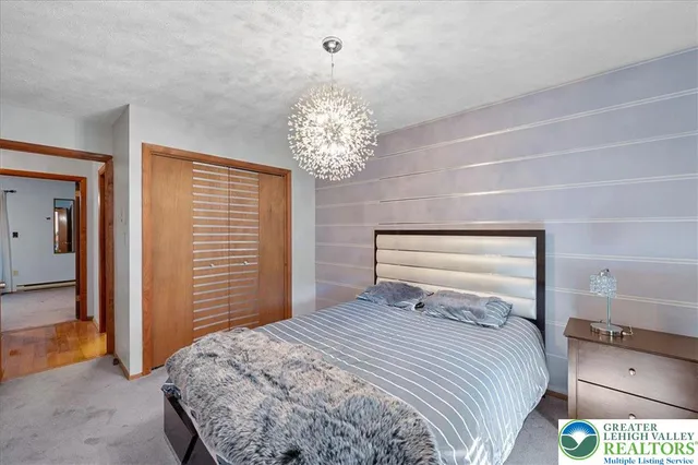 a bedroom with a bed and a chandelier