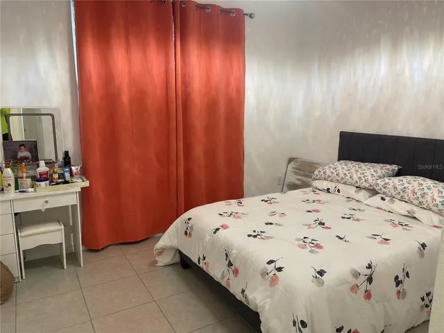 a bedroom with a bed and a table