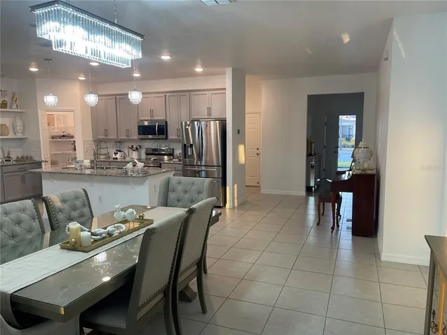 a dining area with a table chairs and entryway