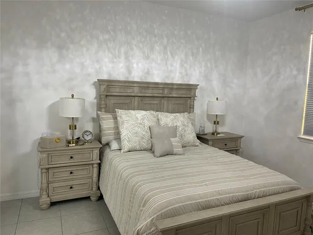 a bedroom with a bed and a dresser