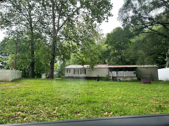 a view of a house with a yard and sitting area