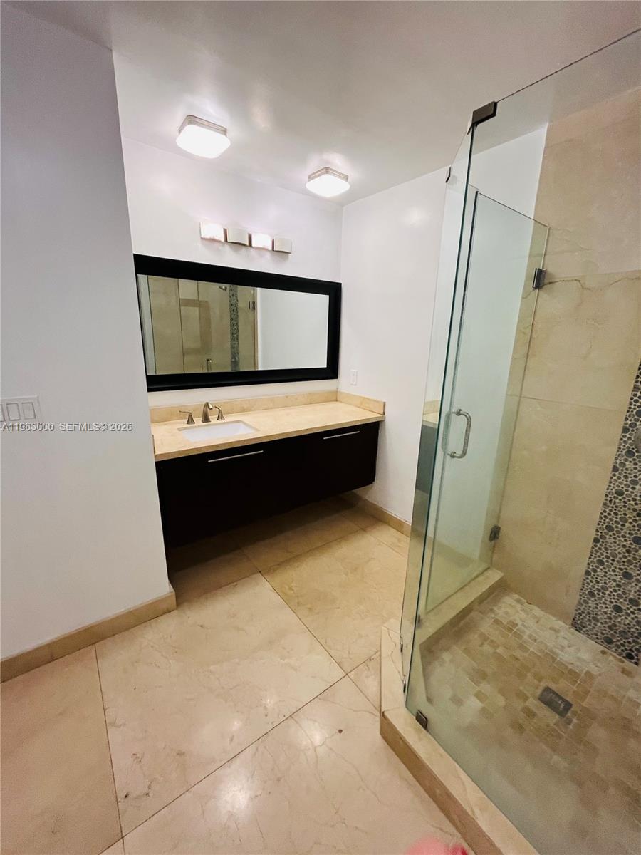 10190 Collins Avenue, Unit 106 Bal Harbour, FL 33154 - Photo 15 of 21 a bathroom with a sink and a mirror
