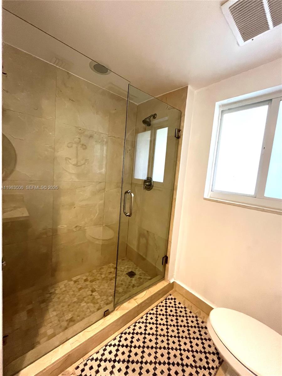 10190 Collins Avenue, Unit 106 Bal Harbour, FL 33154 - Photo 20 of 21 a bathroom with a shower and a toilet