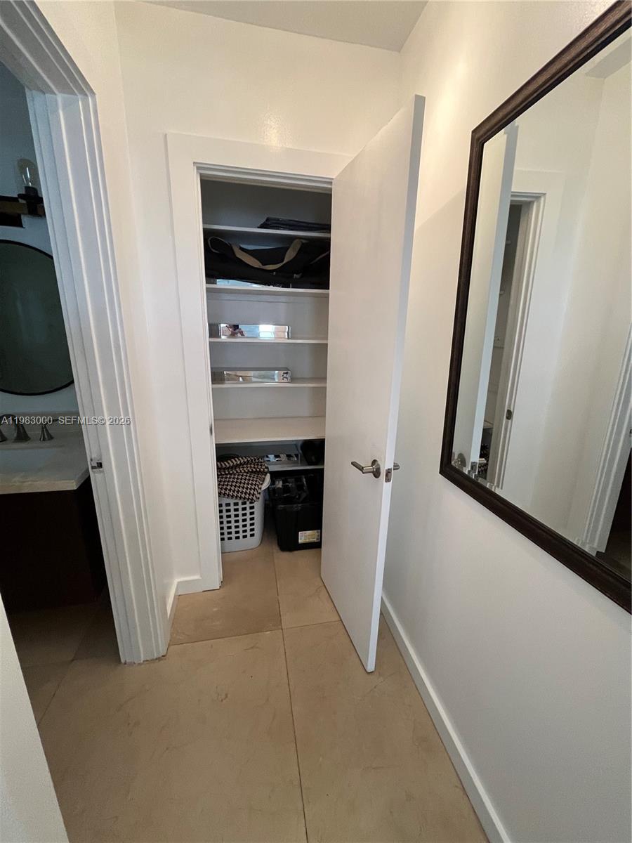 10190 Collins Avenue, Unit 106 Bal Harbour, FL 33154 - Photo 21 of 21 a view of a closet area with furniture and a window