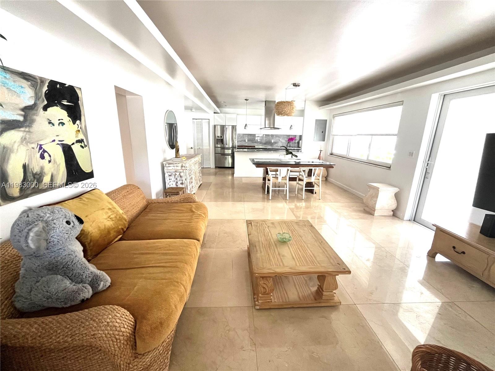 10190 Collins Avenue, Unit 106 Bal Harbour, FL 33154 - Photo 6 of 21 a living room with furniture and a wooden floor