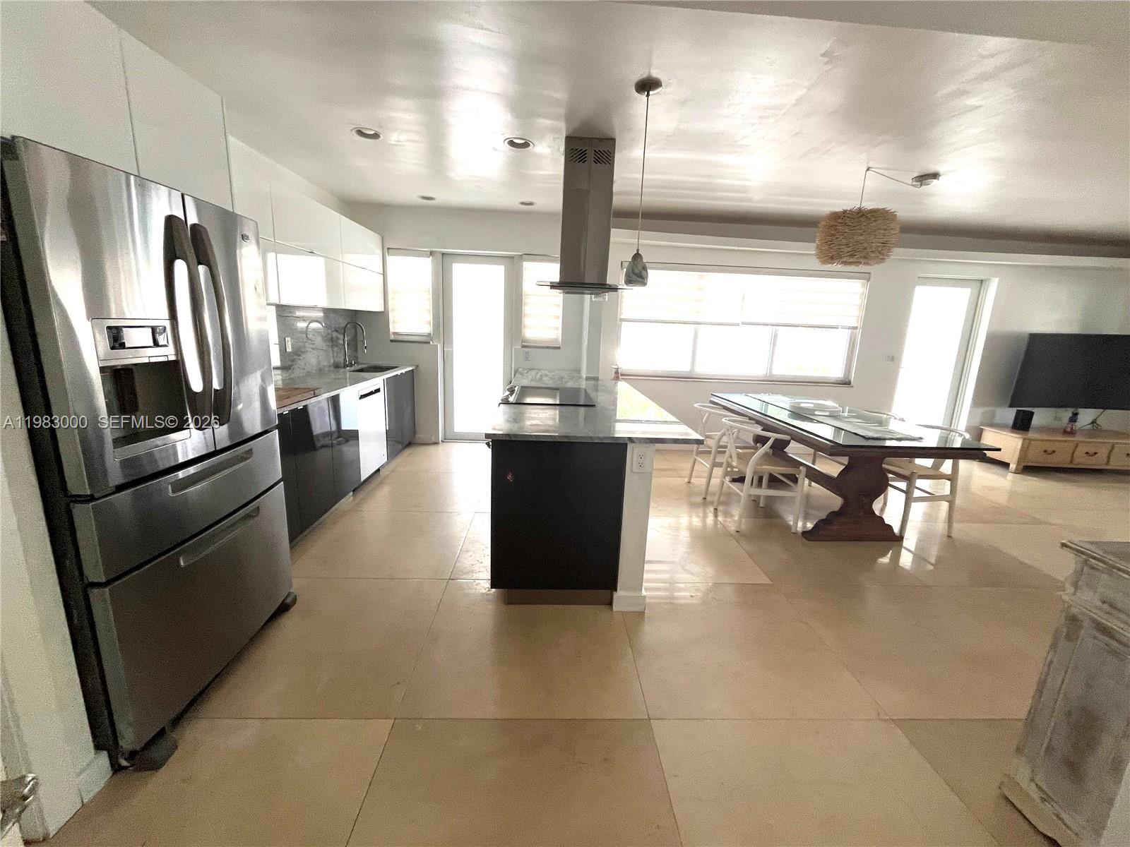 10190 Collins Avenue, Unit 106 Bal Harbour, FL 33154 - Photo 7 of 21 a kitchen with stainless steel appliances granite countertop a refrigerator a stove and a sink