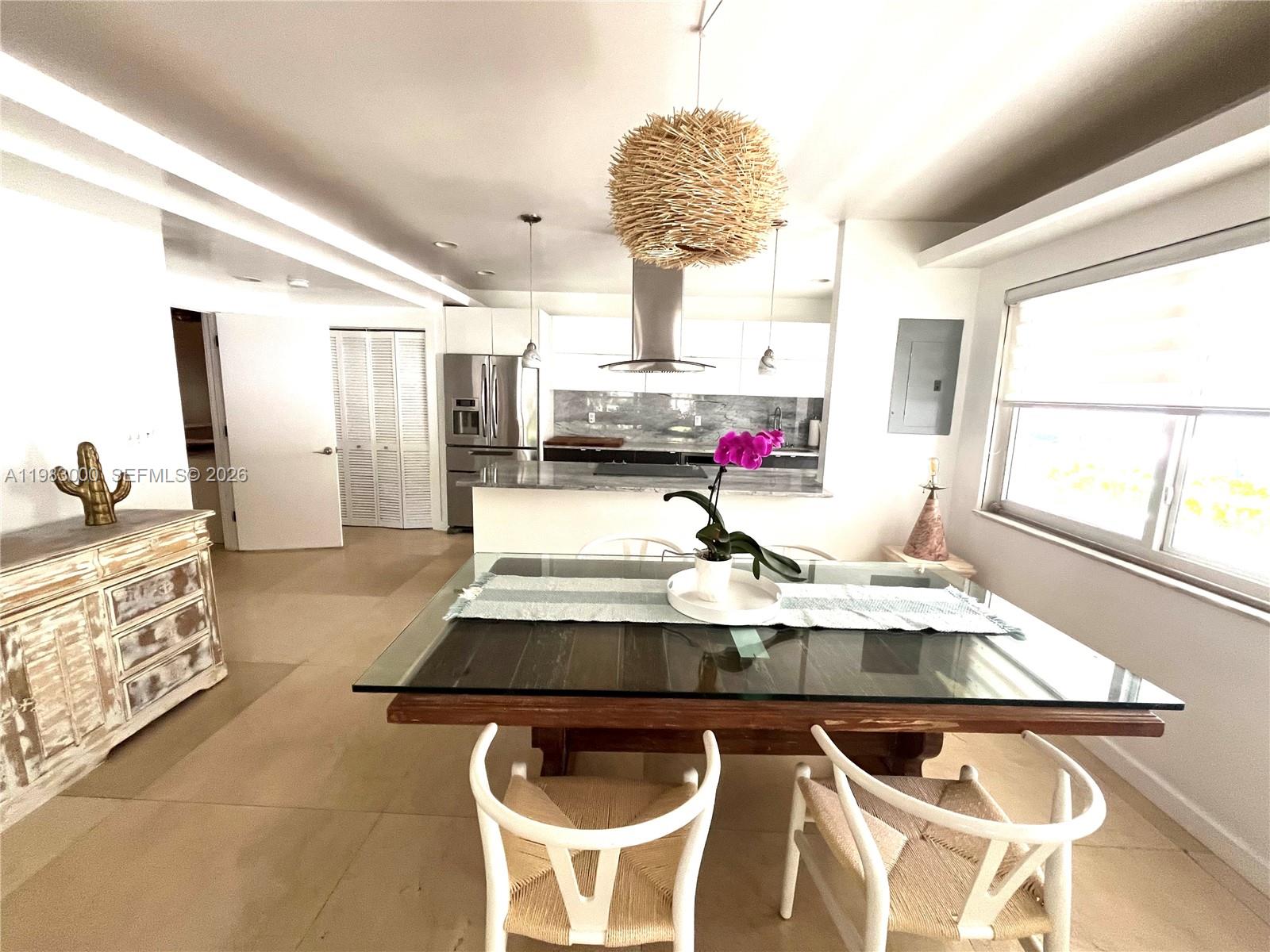10190 Collins Avenue, Unit 106 Bal Harbour, FL 33154 - Photo 10 of 21 a living room with kitchen and furniture