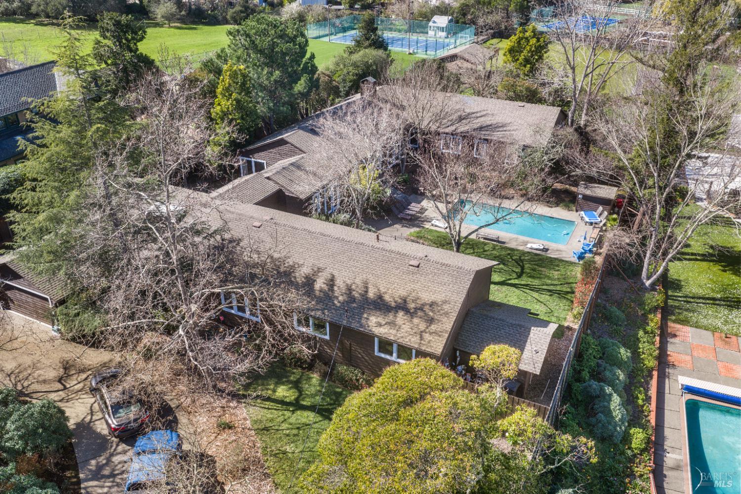 an aerial view of a house with a yard basket ball court and outdoor seating