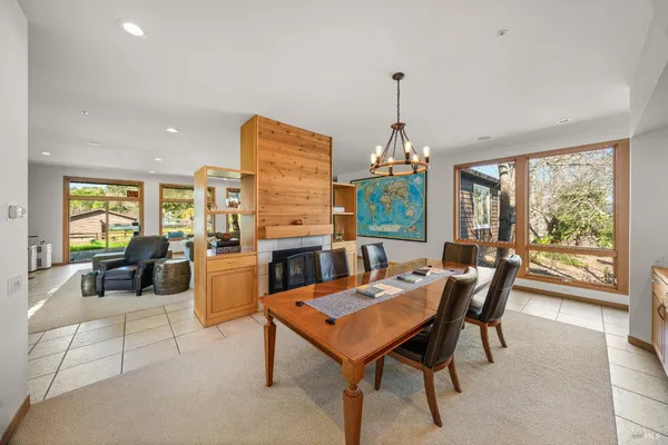a dining room with furniture a chandelier and wooden floor