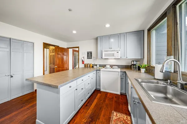 a kitchen with a sink stove top oven and refrigerator