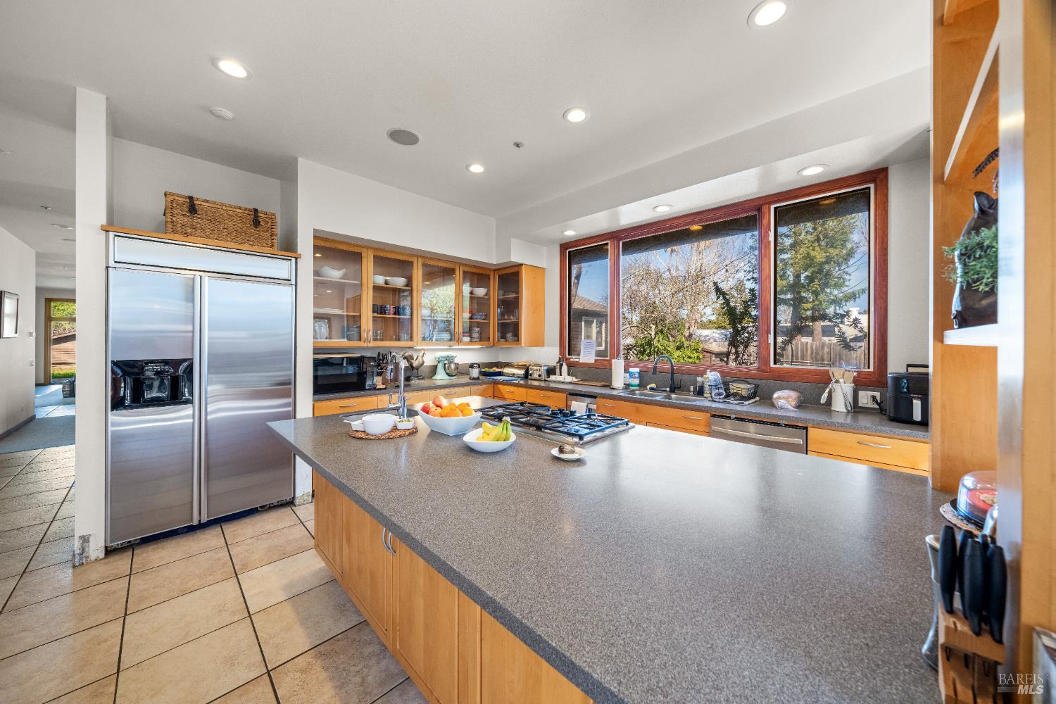 8 Circle Road San Rafael, CA 94903 - Photo 38 of 48 a view of a kitchen with kitchen island a large window cabinets and stainless steel appliances