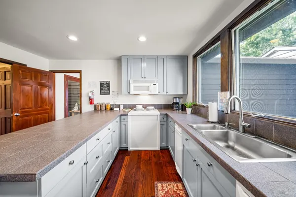 a kitchen with a sink stove and cabinets
