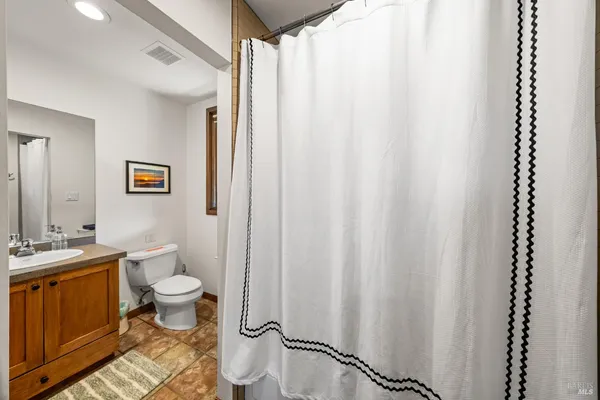 a bathroom with a toilet a sink and a mirror