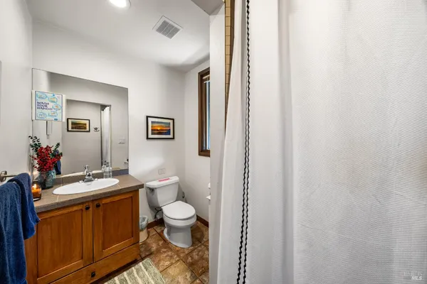 a view of bathroom with a toilet sink and mirror