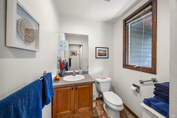 a bathroom with a toilet a sink and a mirror