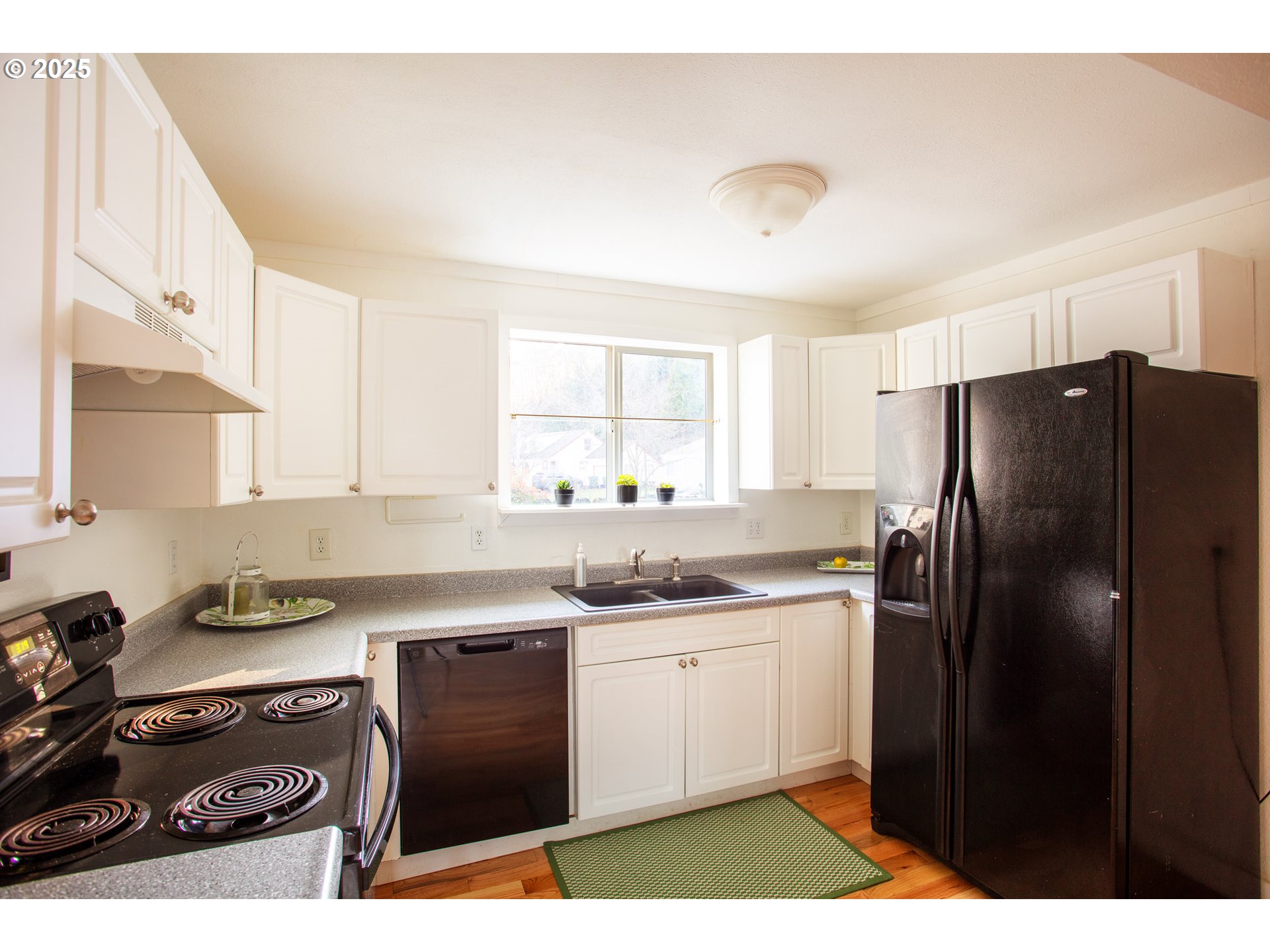 857 Kelly Boulevard Springfield, OR 97477 - Photo 8 of 27 a kitchen with a sink a refrigerator and cabinets