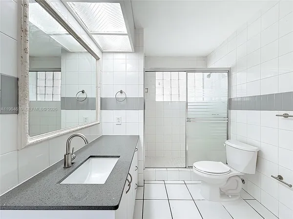 a bathroom with a toilet a sink and a mirror