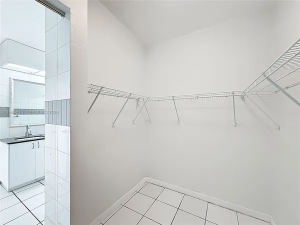 a view of a kitchen with white cabinets and white appliances