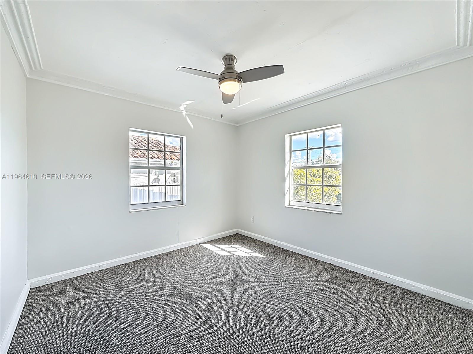 6819 Southwest 25th Street Miami, FL 33155 - Photo 16 of 25 an empty room with windows and fan