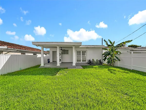 a view of a house with backyard porch and sitting area