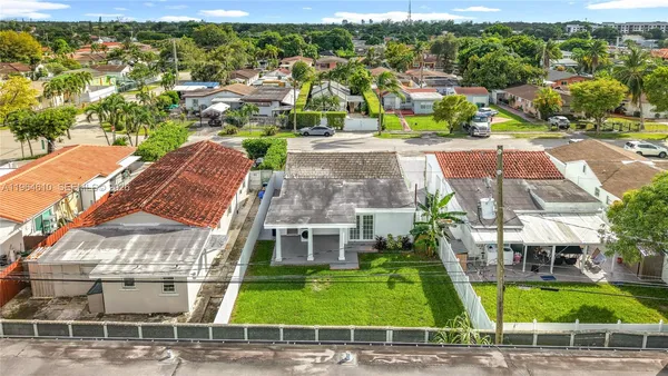 a view of multiple houses with a yard